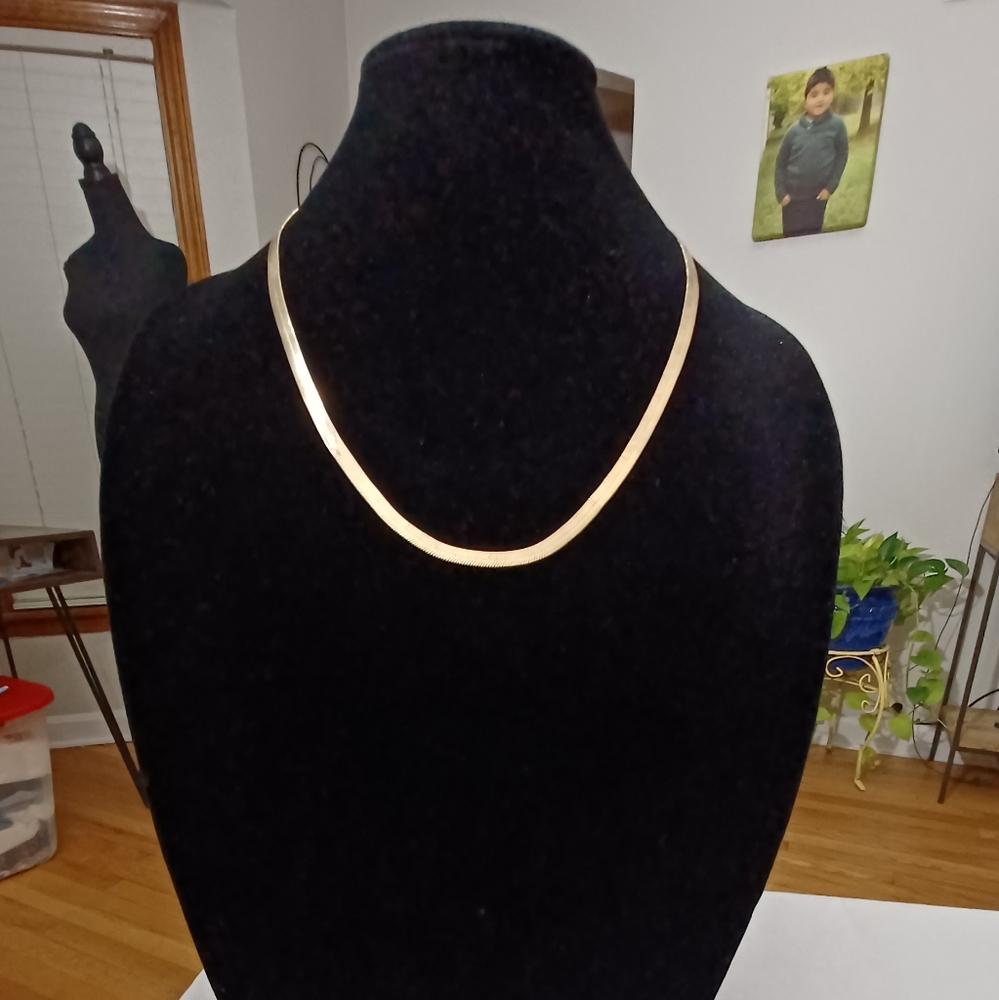 GOLD TONE HERRINGBONE CHAIN.